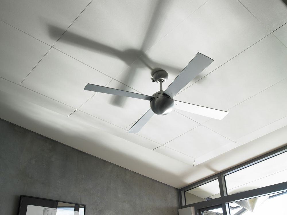 Ceiling Fan on a White Tiled Ceiling Above a Gray Room Wall — LSEA Electrical Group in Bucasia, QLD