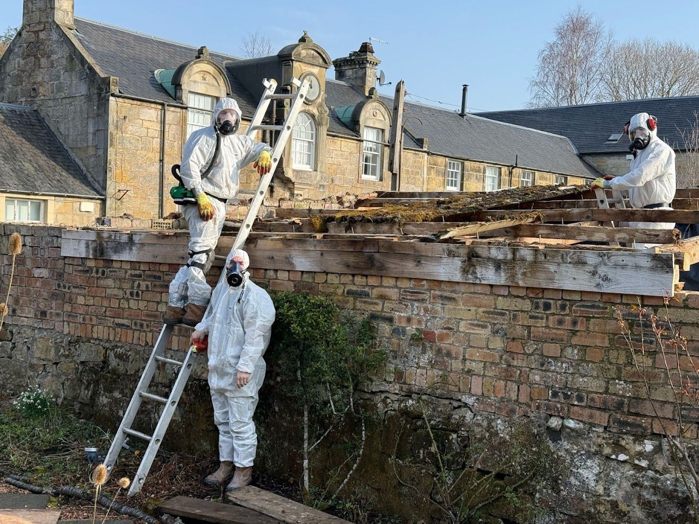 Team of asbestos testing specialists surveying a commercial property for hazards