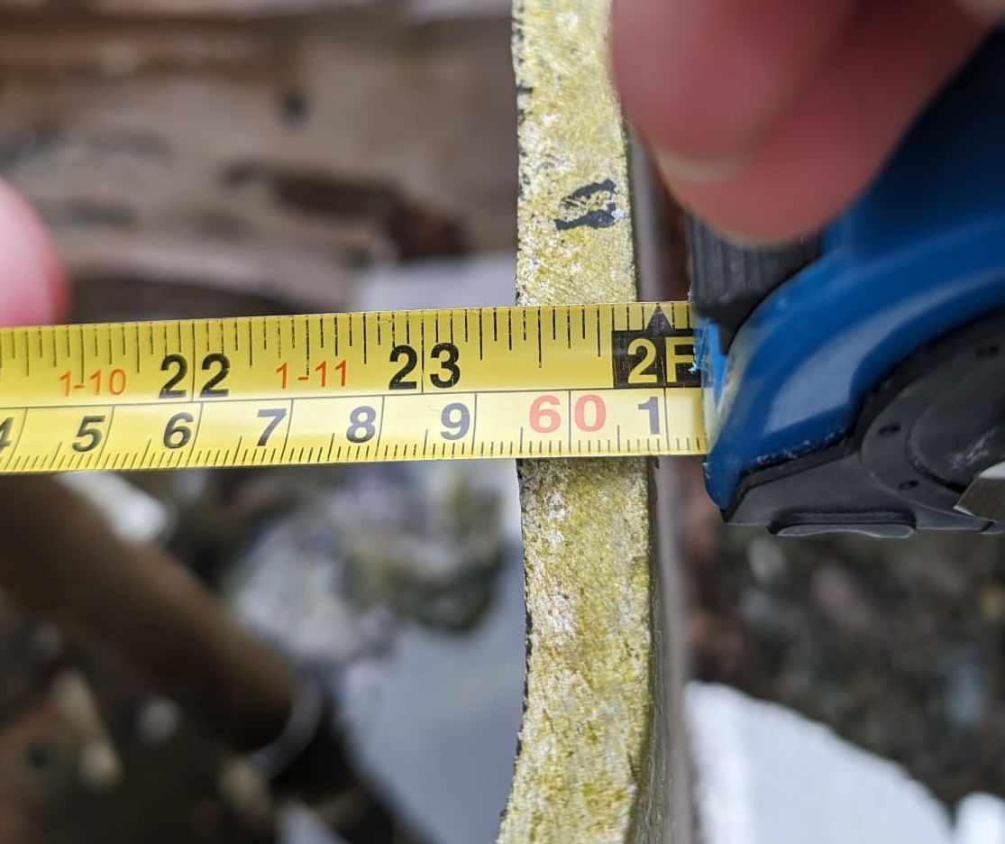 Close-up of asbestos sample being collected from old insulation material.