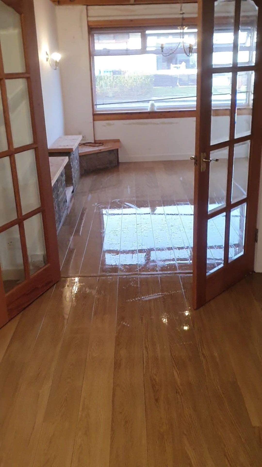 a room with a wooden floor and french doors