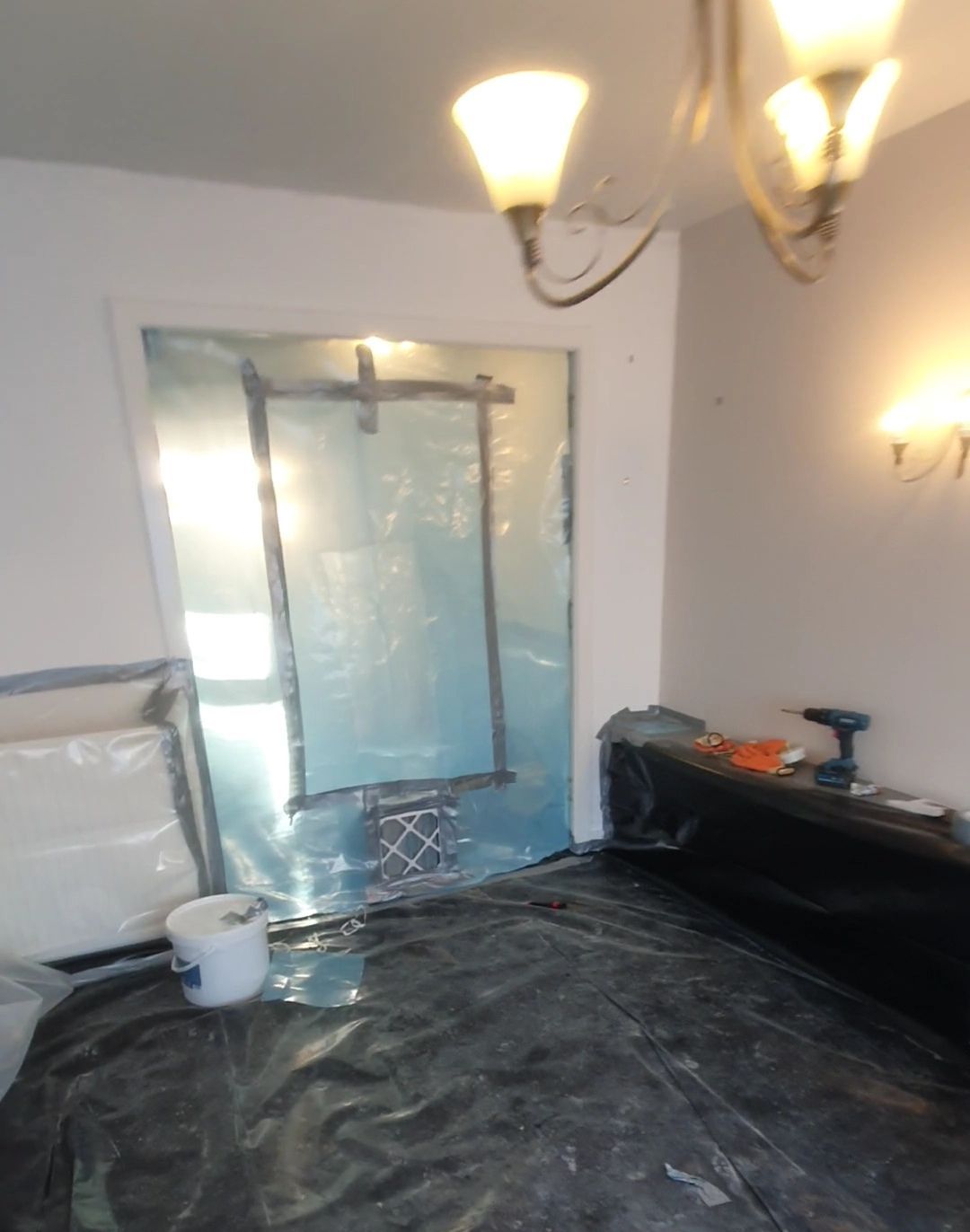 a room with a bucket and a drill on the floor