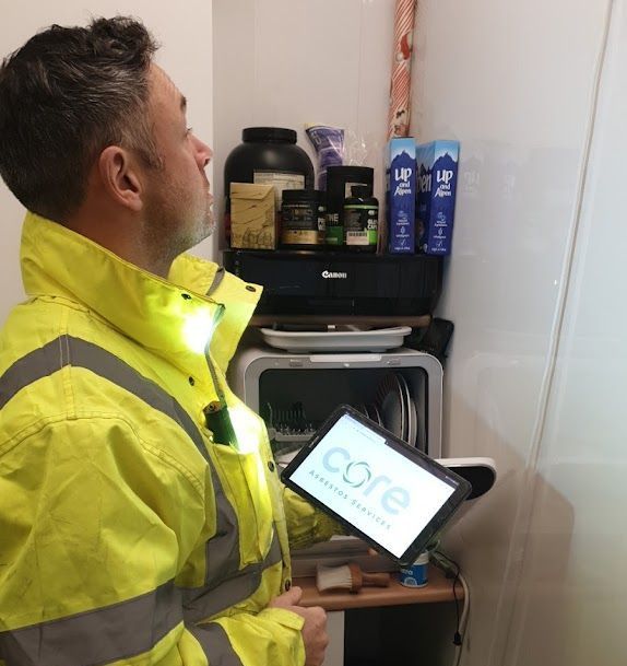 Asbestos testing report showing positive results on a tablet.