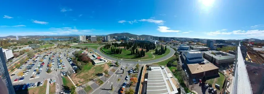 An aerial view of a city with a roundabout in the middle of it.