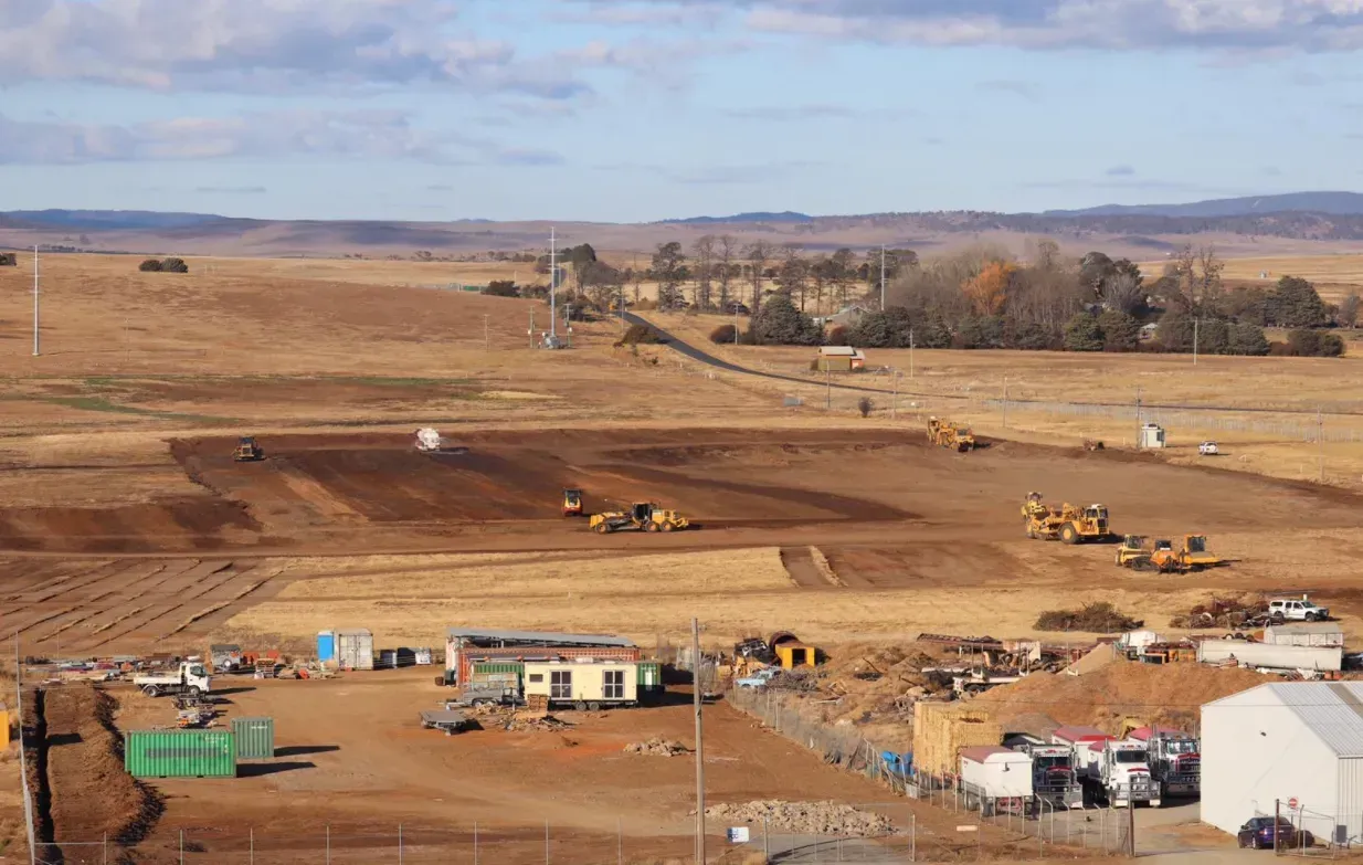 An aerial view of a construction site in the middle of a field.