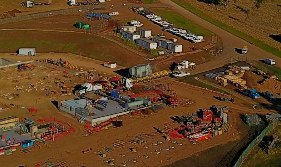 An aerial view of a construction site with a lot of trucks and buildings.