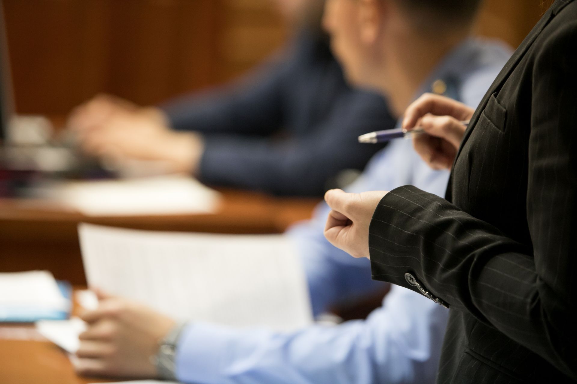 Close-up of a trial in session with lawyer and defendant.