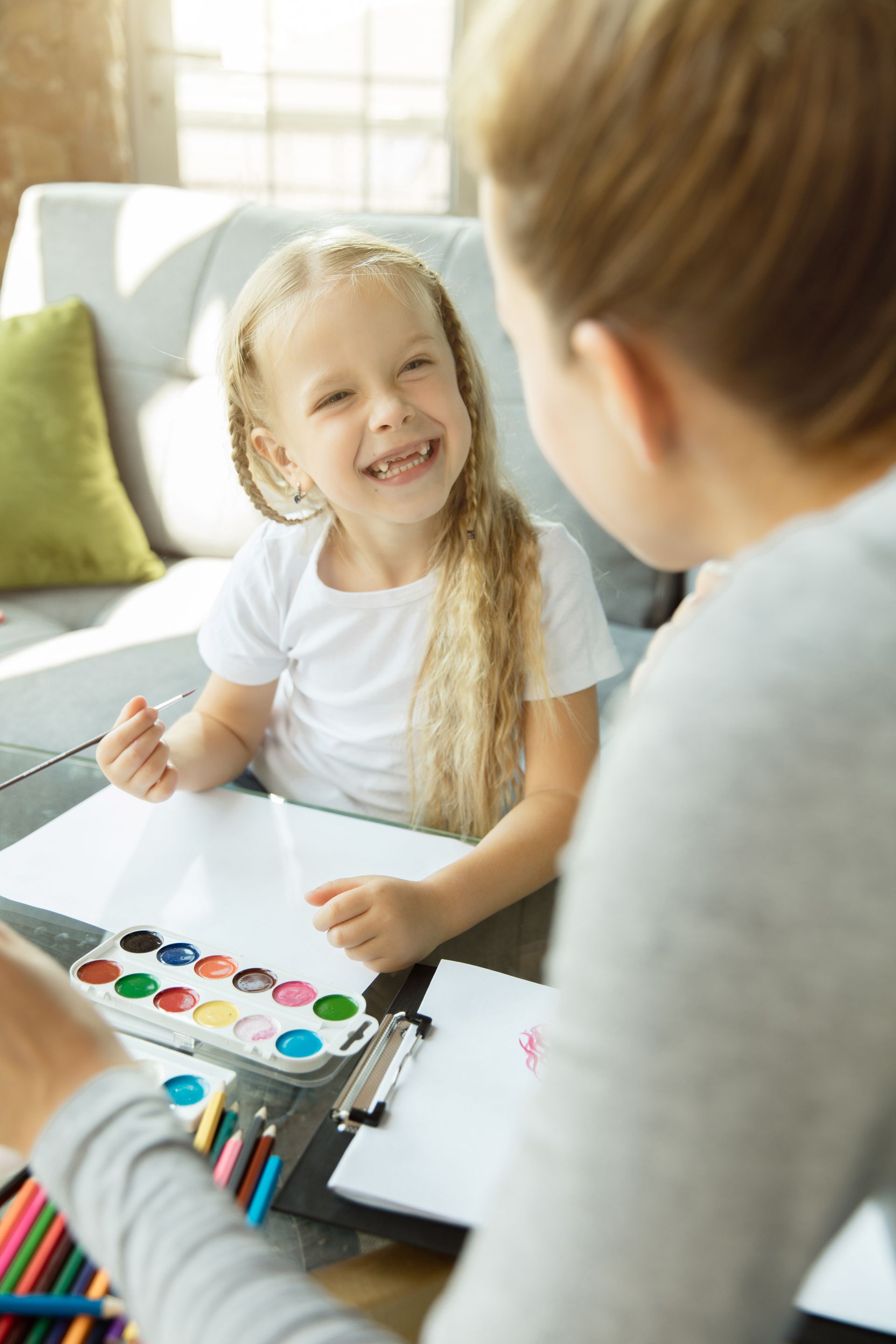 An RBT and a child are playing with blocks on the floor during an in-home aba therapy session