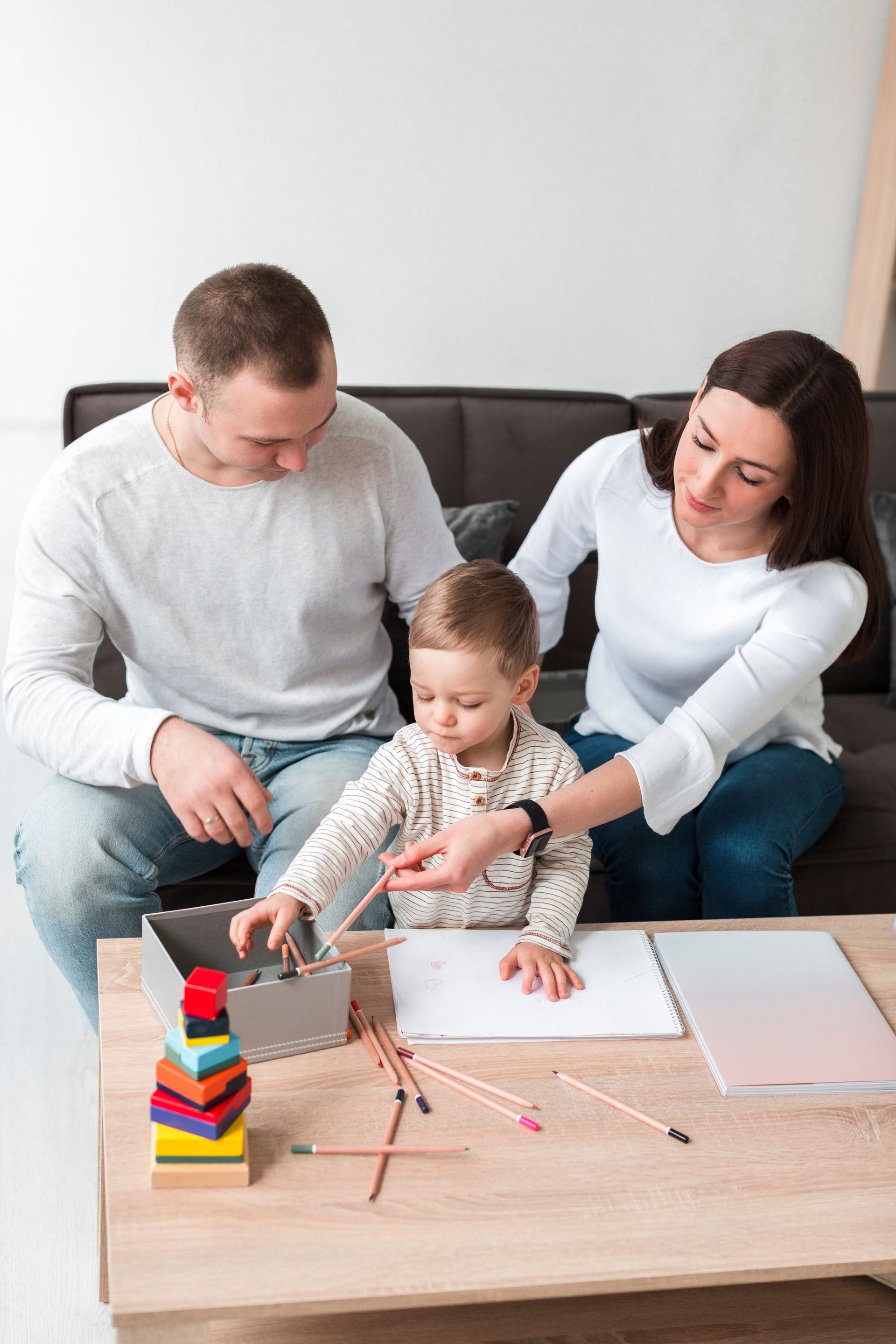 An RBT and a child are playing with blocks on the floor during an in-home aba therapy session