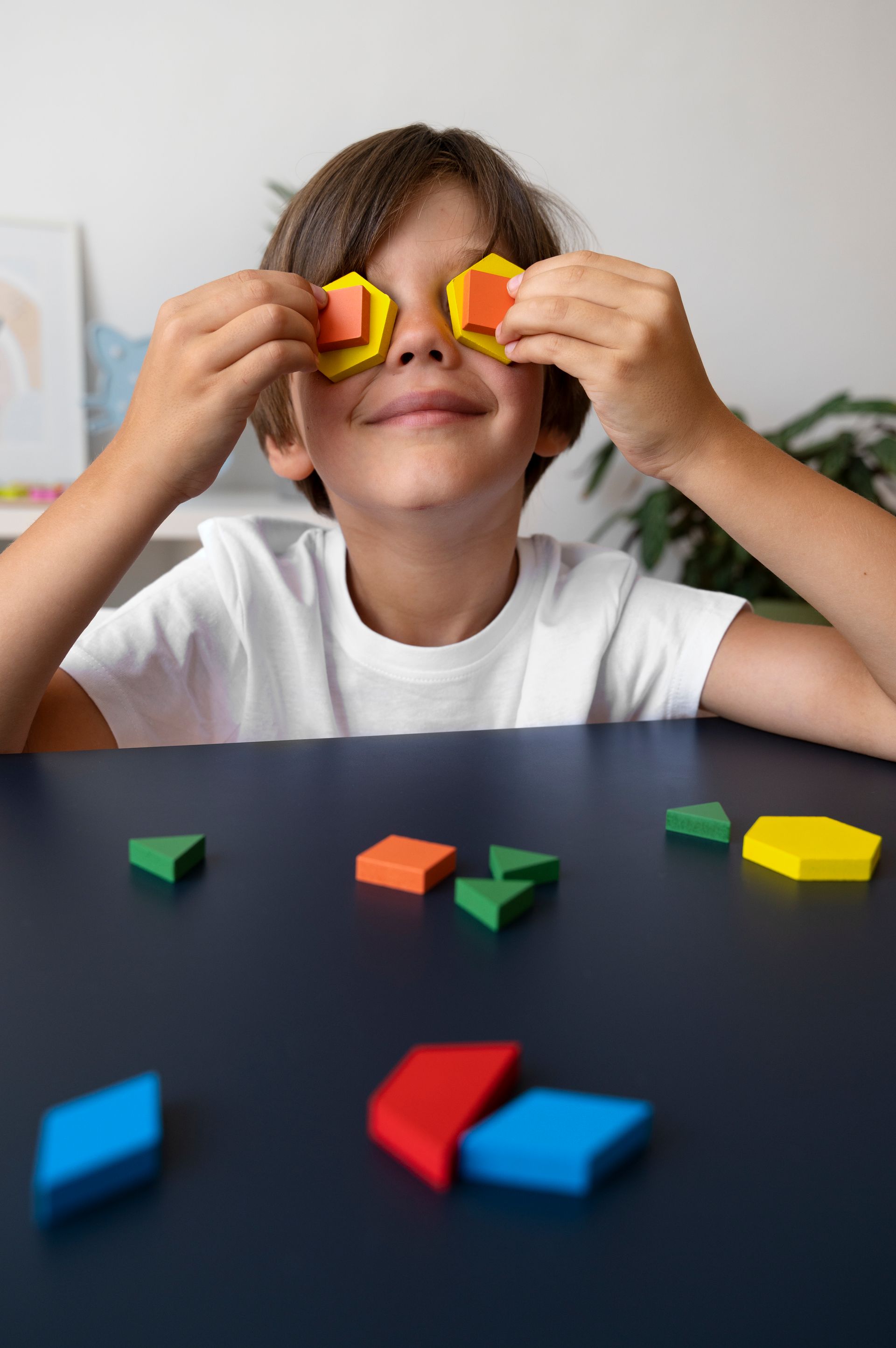 An RBT and a child are playing with blocks on the floor during an in-home aba therapy session
