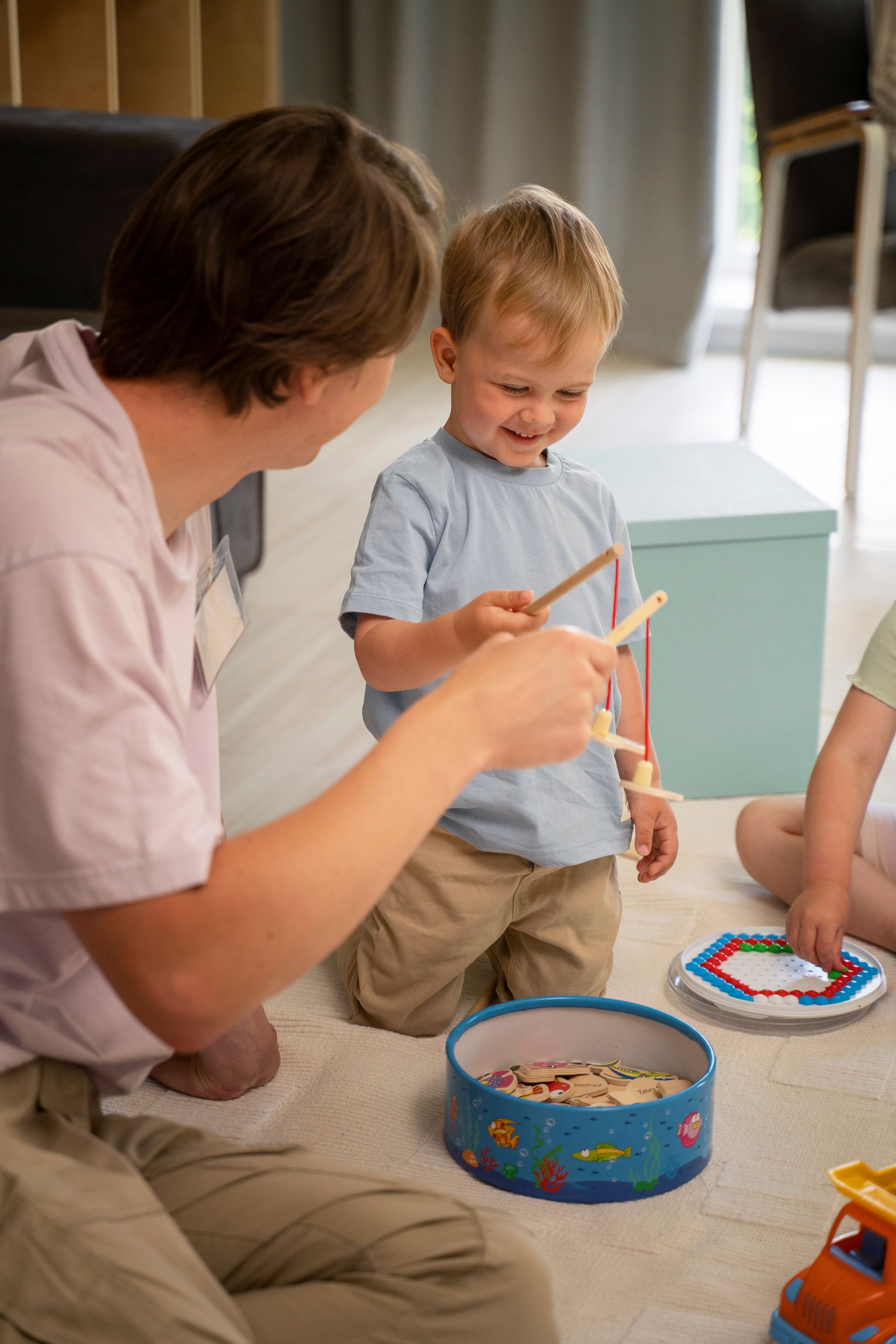 An RBT and a child are playing with blocks on the floor during an in-home aba therapy session