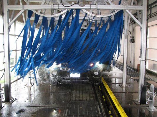 A Car Is Going Through A Car Wash With Blue Brushes - San Pablo, CA - Grand Prix Car Wash San Pablo