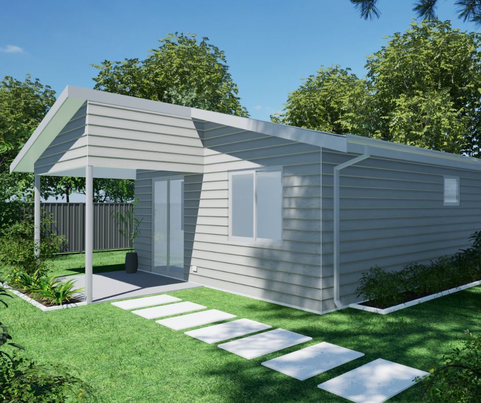 A modern, single-story light gray house with a covered patio, a small window, and a white stone walkway on a green lawn.