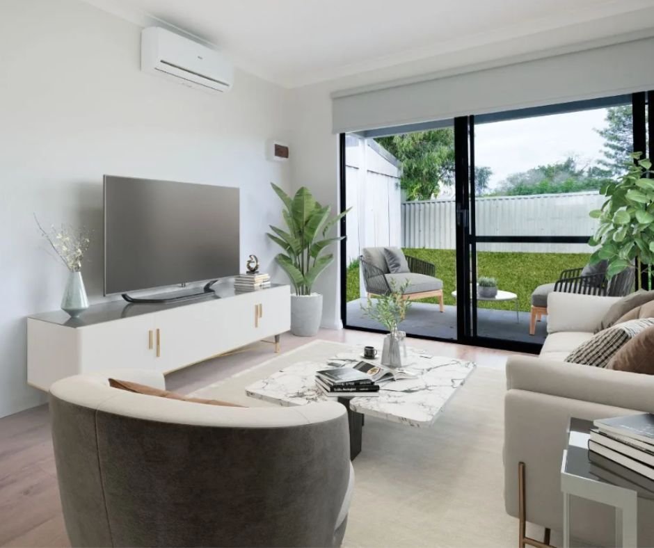 A modern living room with a white media console, a television, a marble coffee table, armchairs, and a view of a patio.