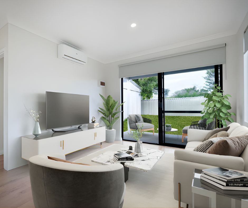 Modern living room with a white media console, flat-screen TV, cream sofa, armchair, and sliding glass doors to a patio.