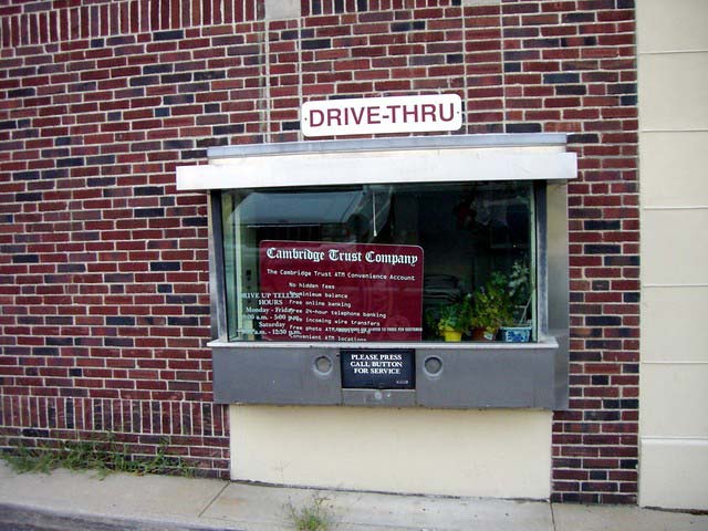 A drive thru window in a brick building
