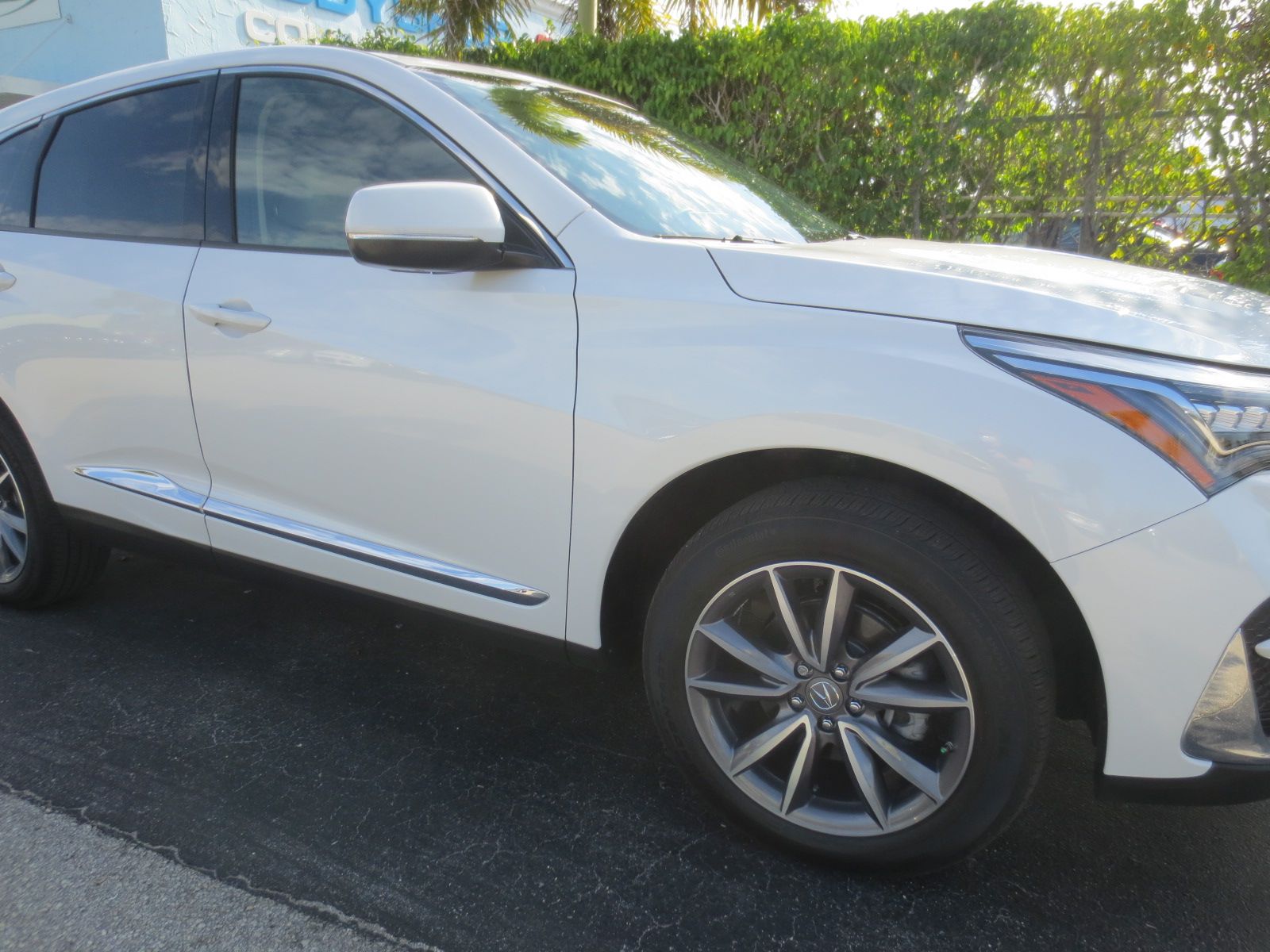 A white car is parked on the side of the road | B & R Auto Body Works