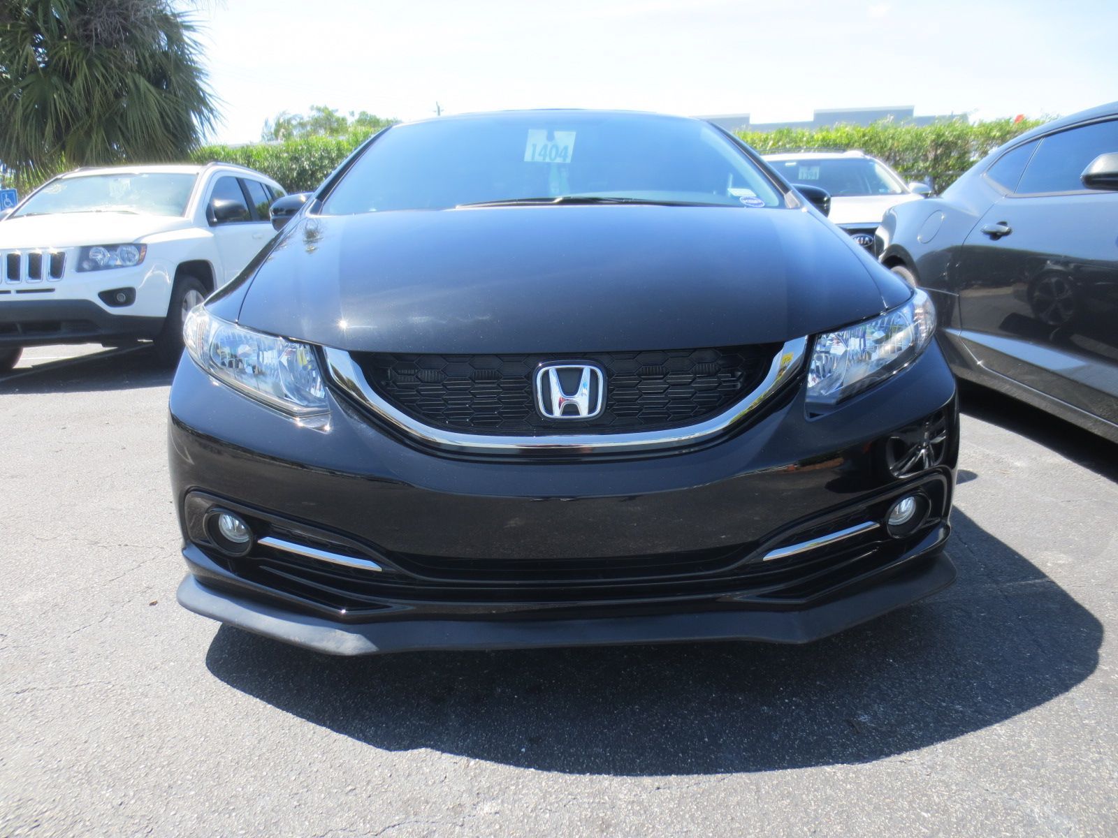 A black honda civic is parked in a parking lot | B & R Auto Body Works