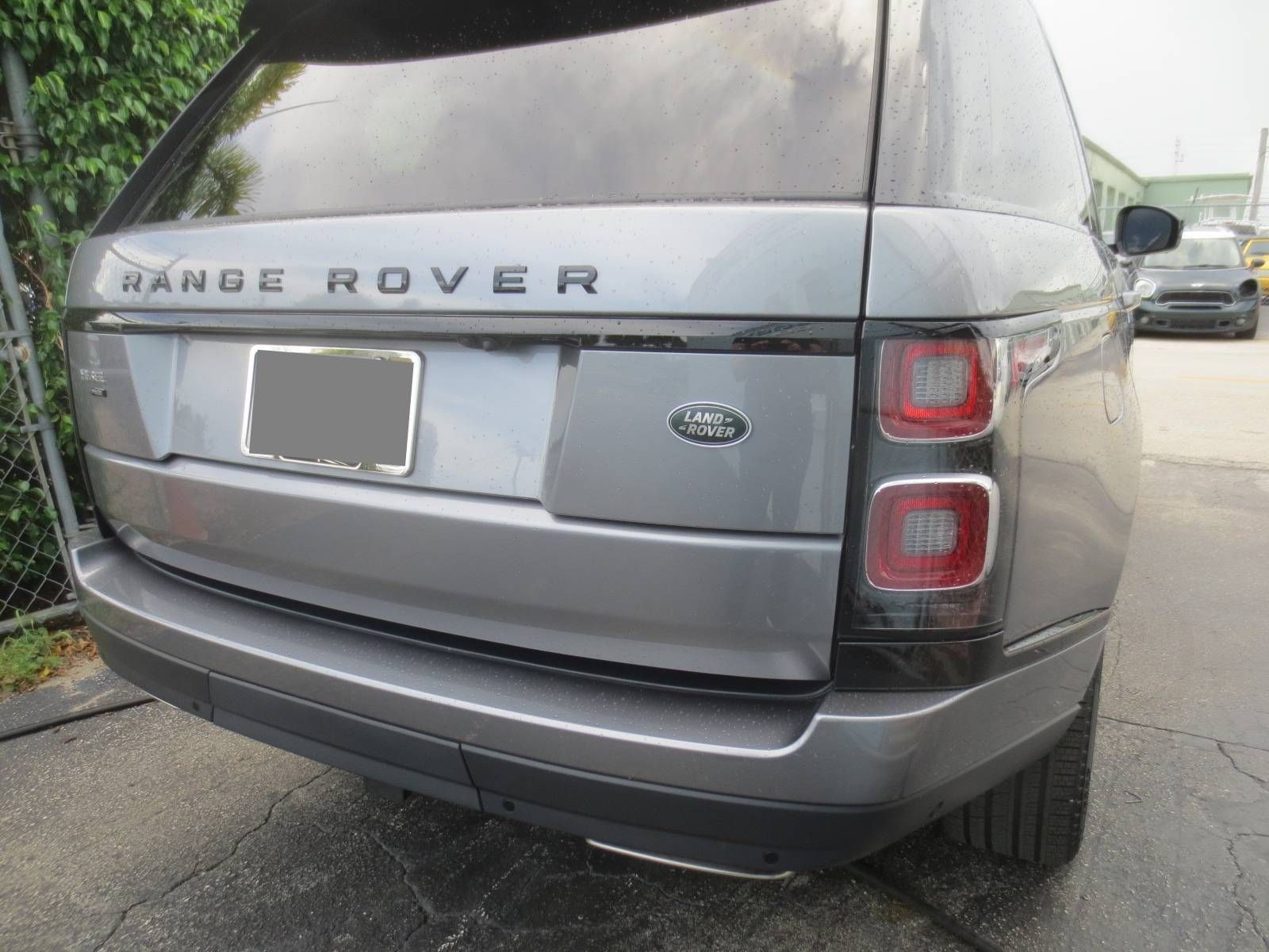 A gray range rover is parked on the side of the road. | B & R Auto Body Works