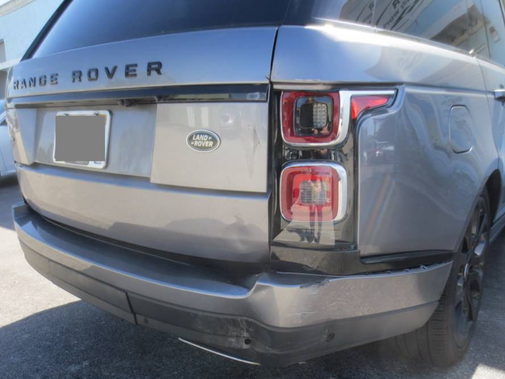 The back end of a range rover with a damaged bumper | B & R Auto Body Works