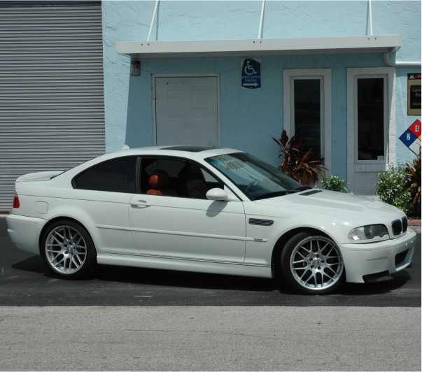 A car is parked in front of a building that says b & r auto body works | B & R Auto Body Works