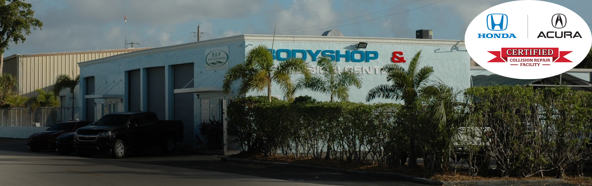 A body shop with cars parked in front of it | B & R Auto Body Works