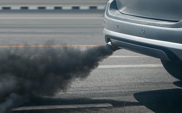 Car exhaust pipe emitting thick black smoke on a road | Jeff's Automotive, Inc