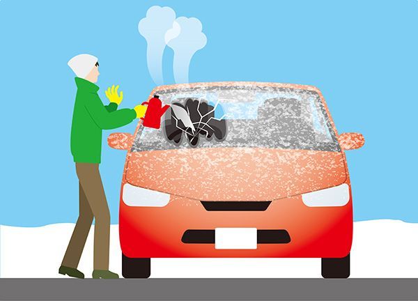 Person scraping ice off a red car windshield on a snowy day | Jeff's Automotive, Inc