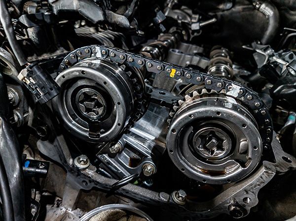 Close-up of industrial metal gears and circular machine parts in a dark mechanical assembly | Jeff's Automotive, Inc