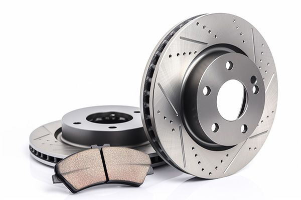 Car brake rotors and pads on a white background | Jeff's Automotive, Inc