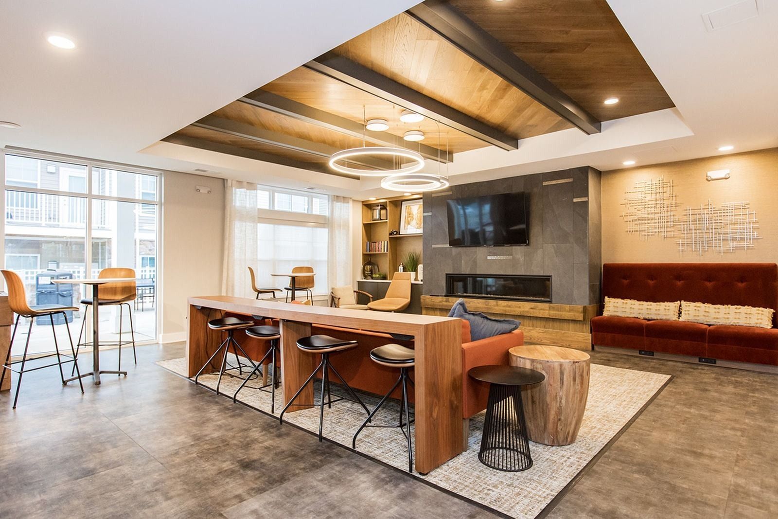 Modern clubhouse lounge with seating and entertainment space at The Villas at Mill Run Apartments in Owings Mills, MD.