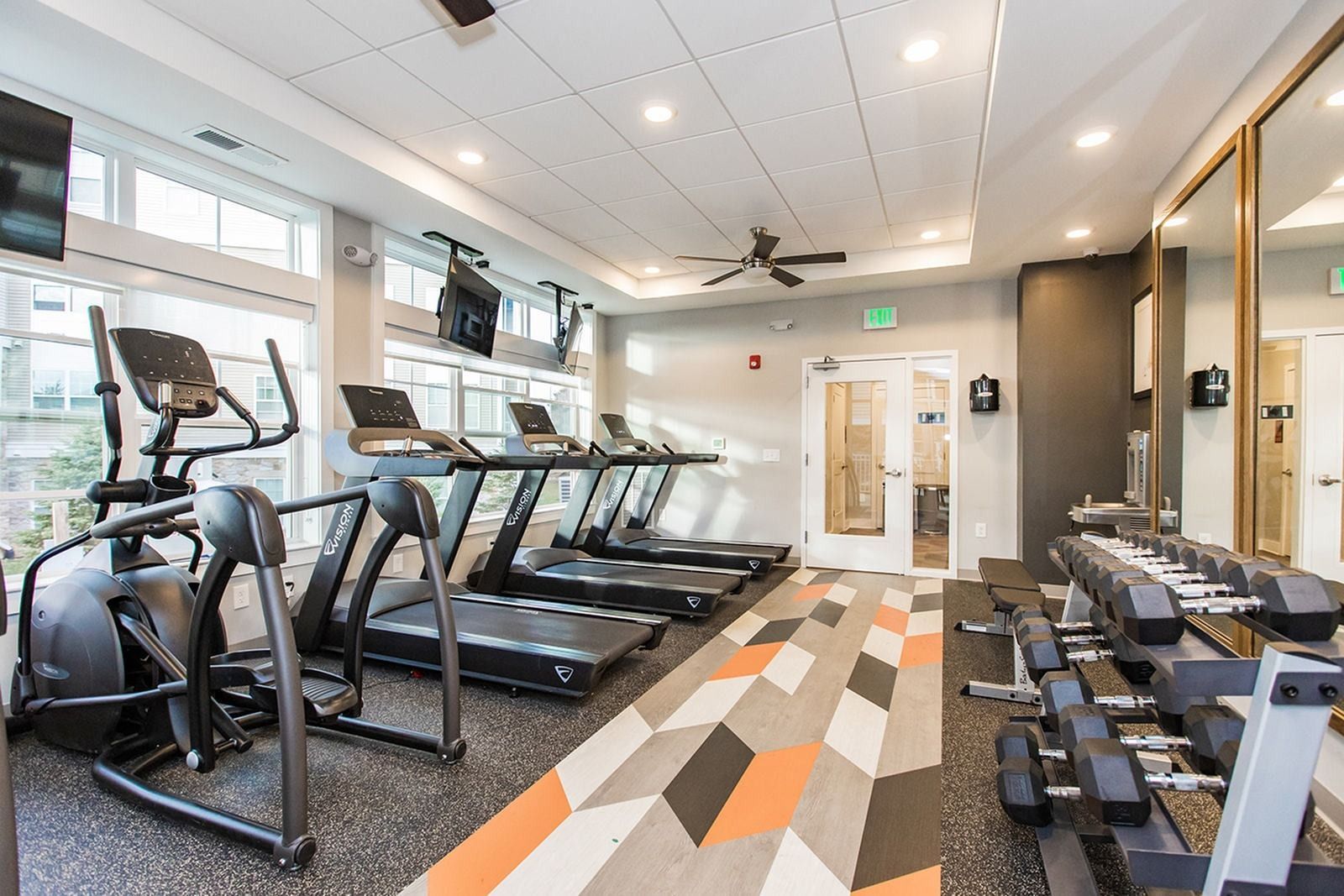 Fitness center with cardio equipment and free weights at The Villas at Mill Run Apartments in Owings Mills, MD.
