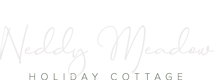 Logo reading “Neddy Meadow Holiday Cottage” in light gray script and serif text on a white background