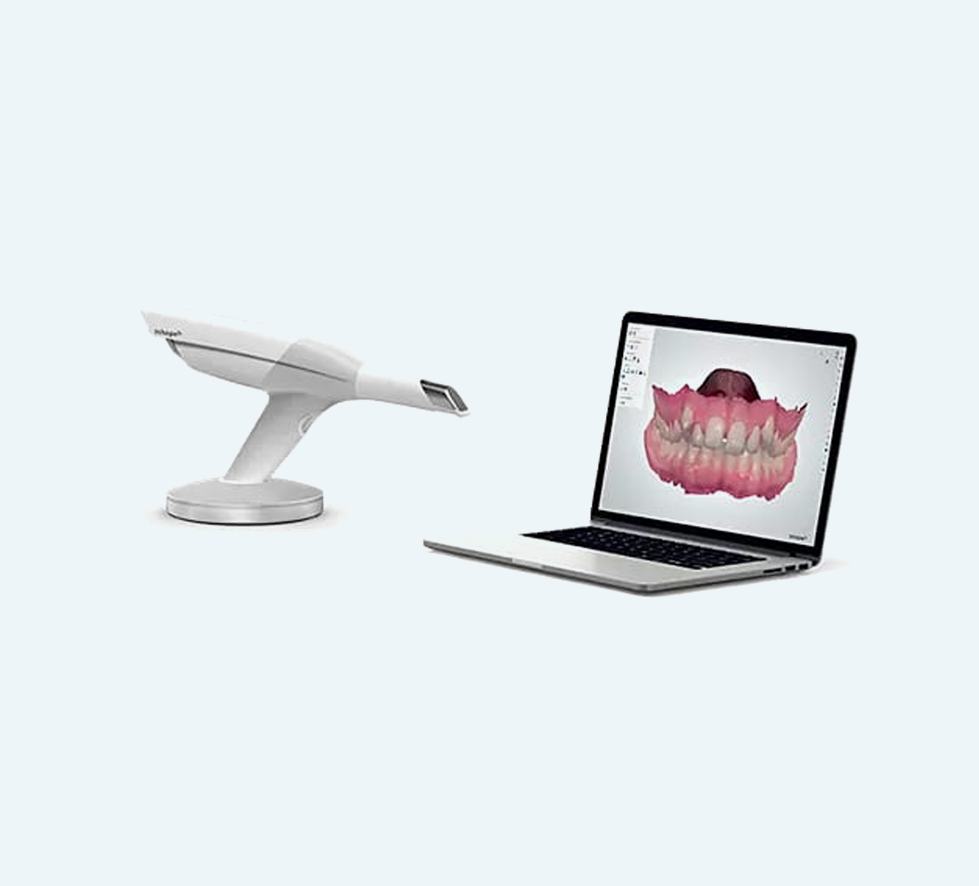 Dental scanner next to laptop displaying 3D teeth model. White background.