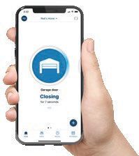 Hand holding a smartphone showing a hotel app with a blue bed icon and the word “Closing” on screen