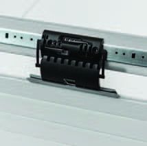 Black plastic paper punch on a metal rail clipboard clasp against a white background