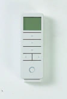 Wall-mounted white remote control with a small green display and several buttons