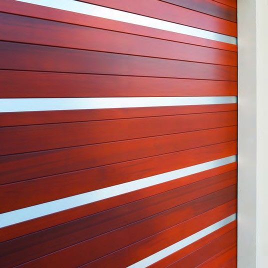 Red metal wall with horizontal silver stripes