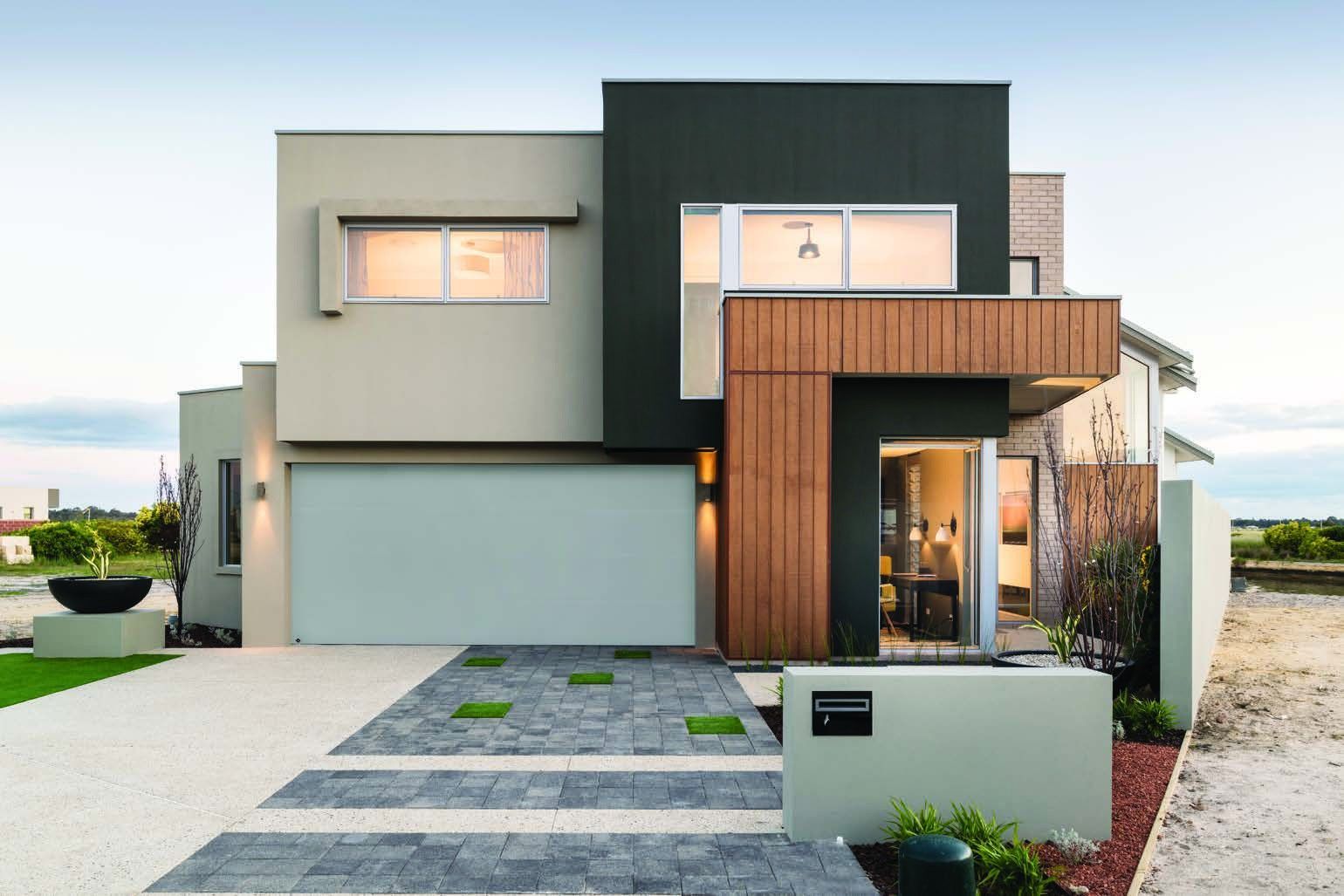 Modern two-story house with gray and wood exterior, front driveway, and landscaped entrance