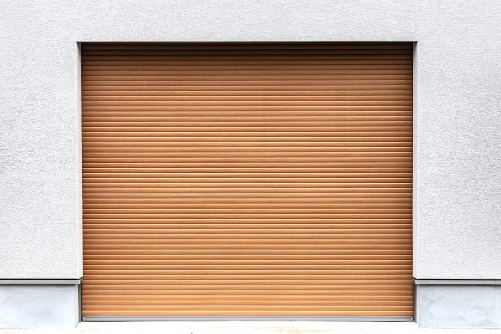 Closed brown rolling garage door set in a white wall
