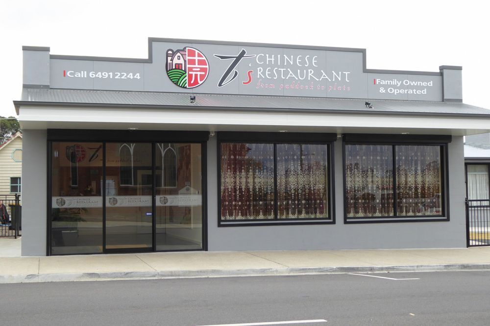 Front view of a Chinese restaurant storefront with gray facade and glass doors.