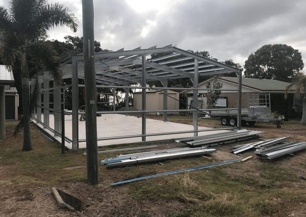 Worker with Dog Beside — Designer Shed in Yeppoon, QLD