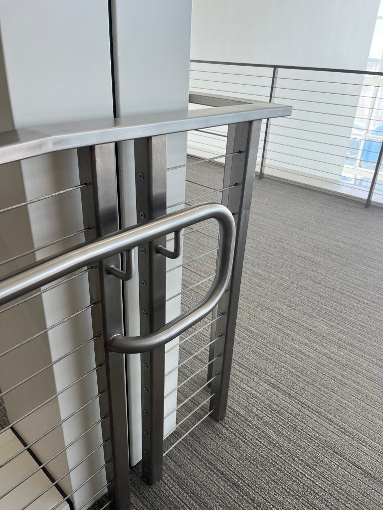 Polished metal handrail beside stairway for safety
