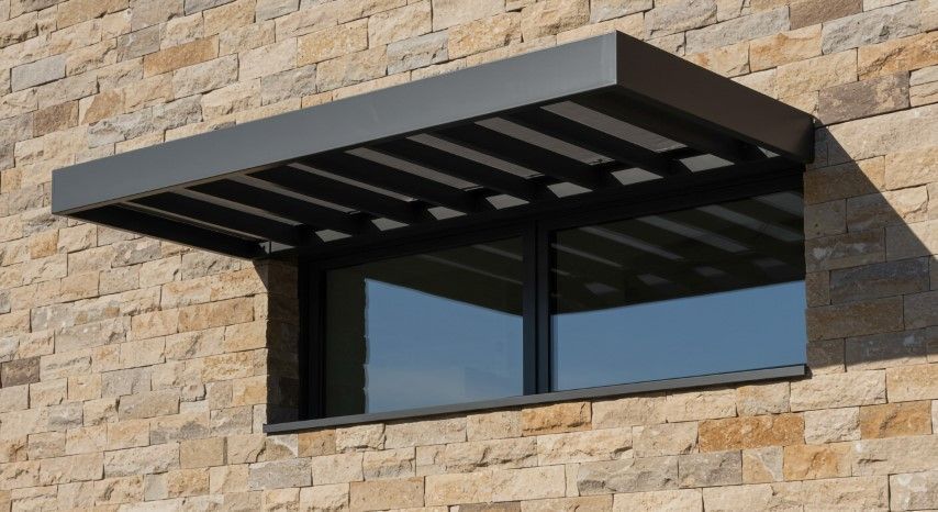 Stone facade with awning-covered window
