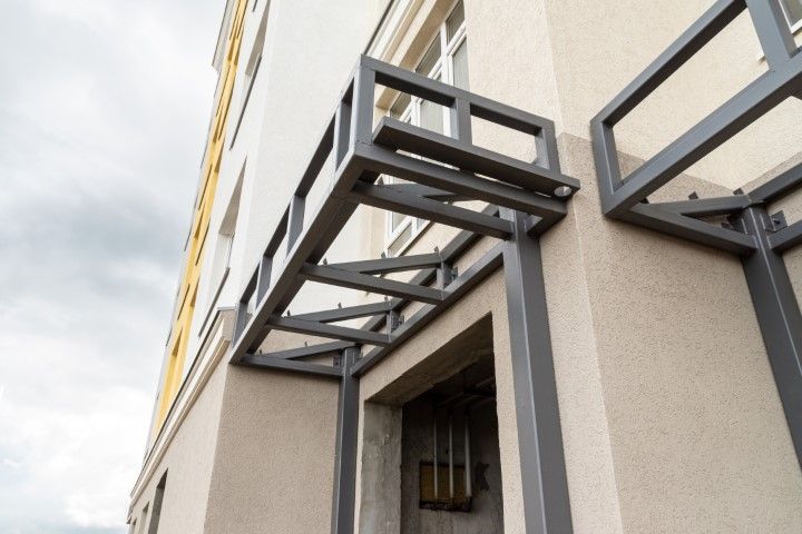 Window with metal awning above commercial entrance in Newton, KS