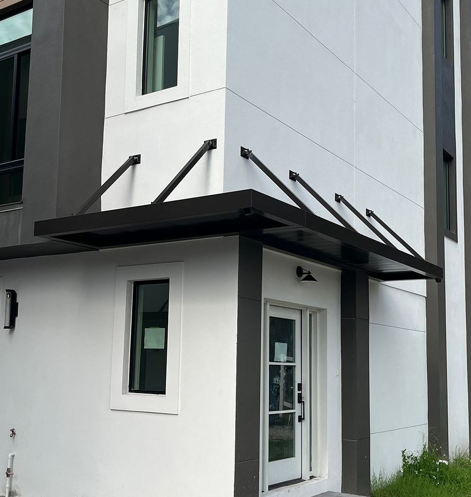 newly constructed metal awning hung over new townhomes