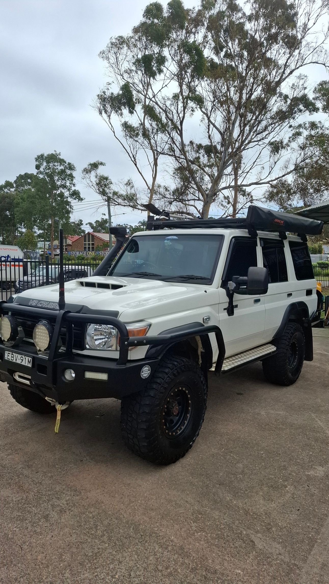 A white toyota land cruiser is parked in a parking lot. — Ocean Glow Car Detailing in Long Jetty NSW