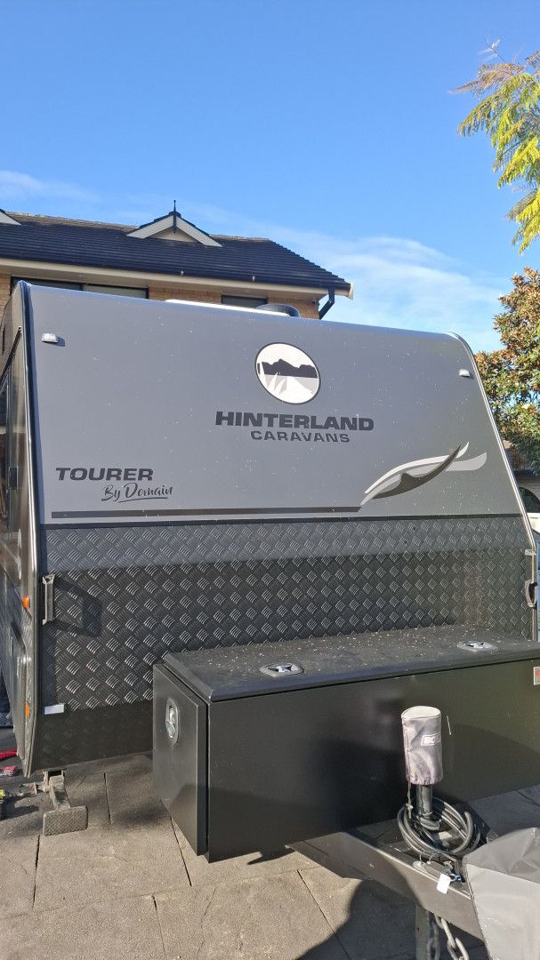 Interior of a motorhome; kitchen area with cabinets, sink, and seating — Ocean Glow Car Detailing in Gorokan, NSW