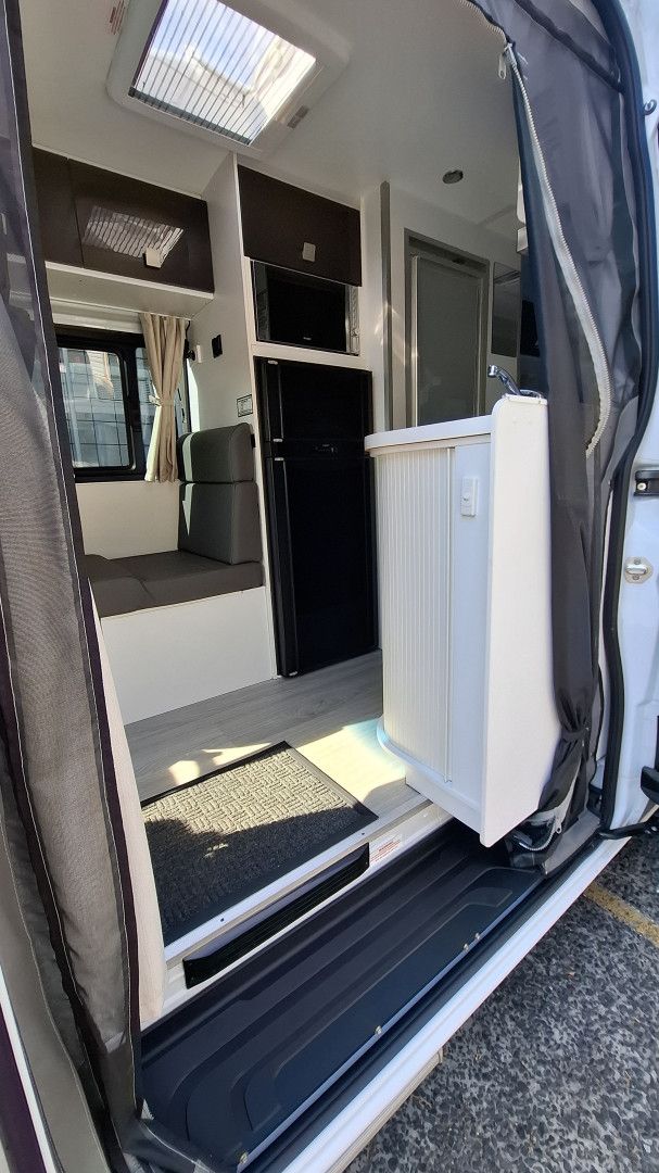 White Rv Parked on a Grassy Area — Ocean Glow Car Detailing in Gorokan, NSW