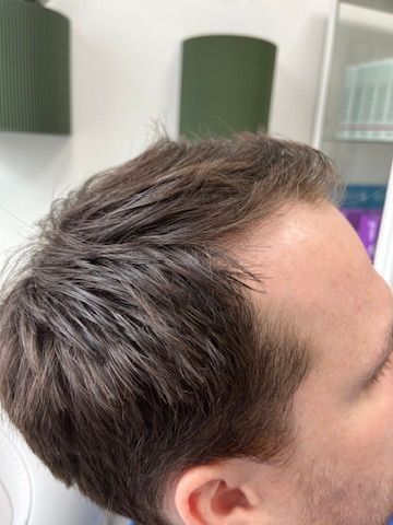 A close up of a man 's head with his eyes closed.