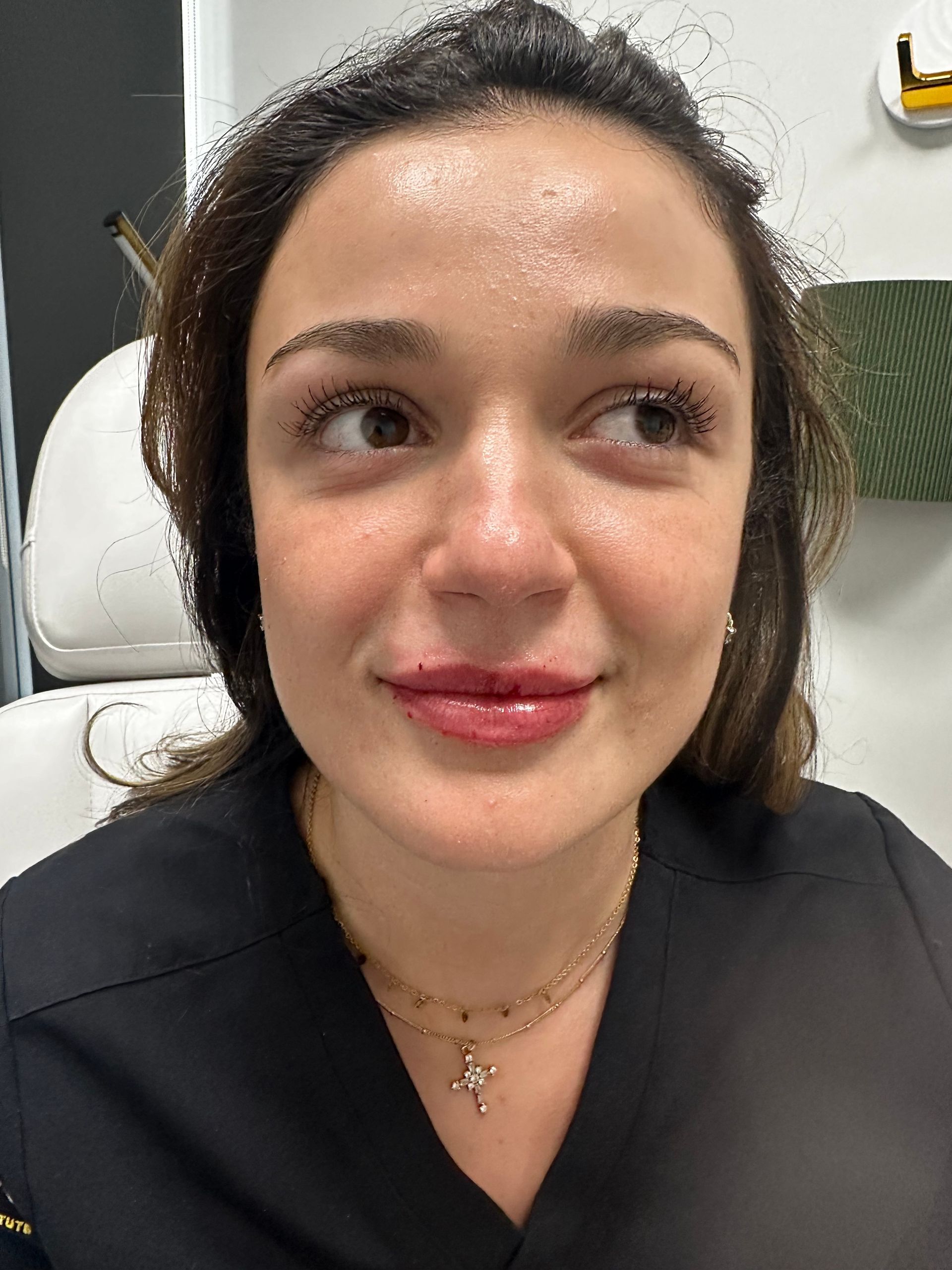 A close up of a woman 's face with a necklace around her neck.